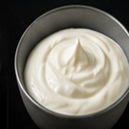 Plain yoghurt specimen photographed on a black background